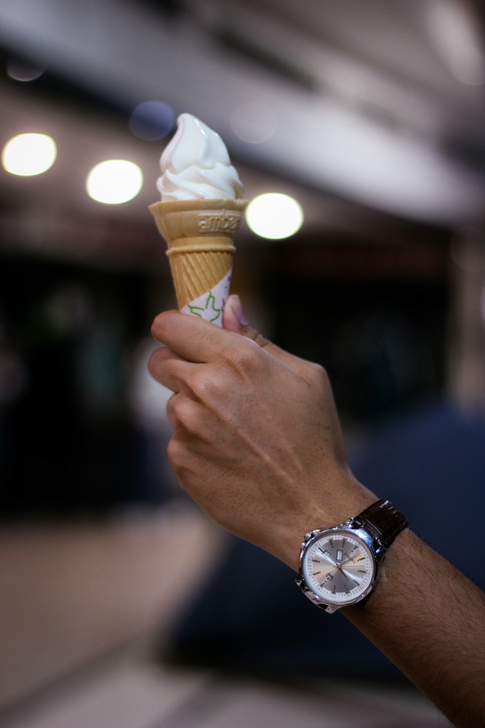 a person holding an ice cream cone in their hand