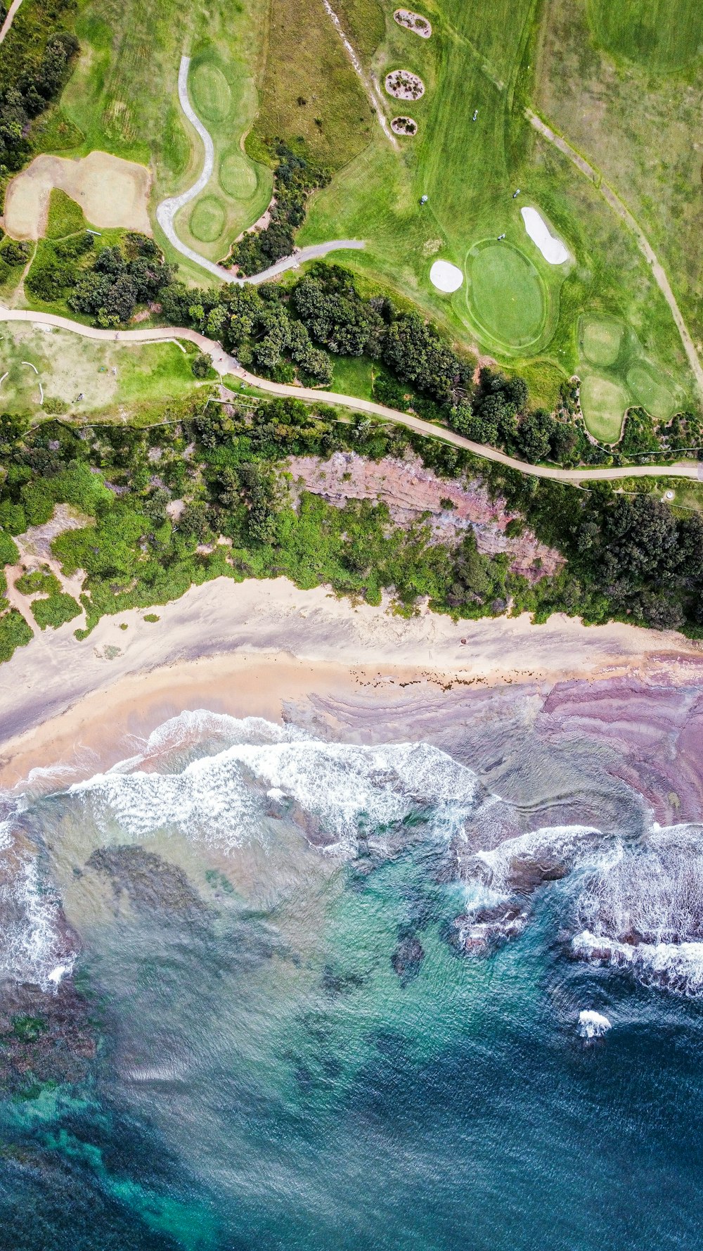 an aerial view of a golf course near the ocean