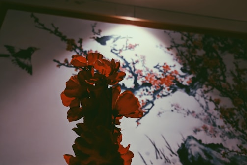 Close-up of a surreal painting featuring Japanese cherry blossoms intertwined with coastal elements.