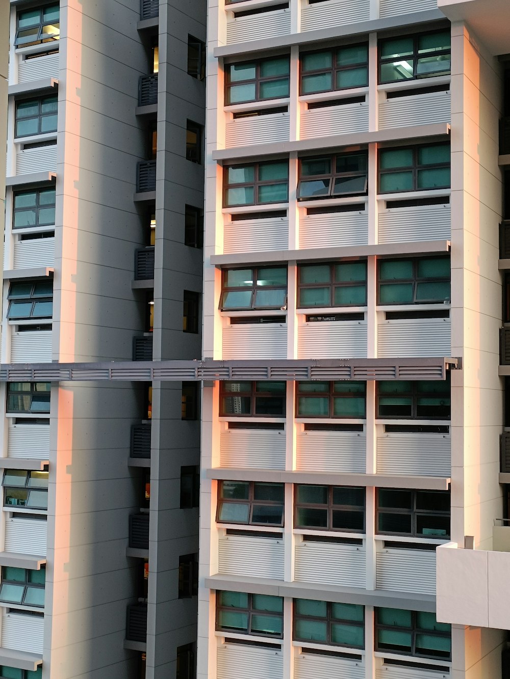 a tall building with multiple balconies next to it