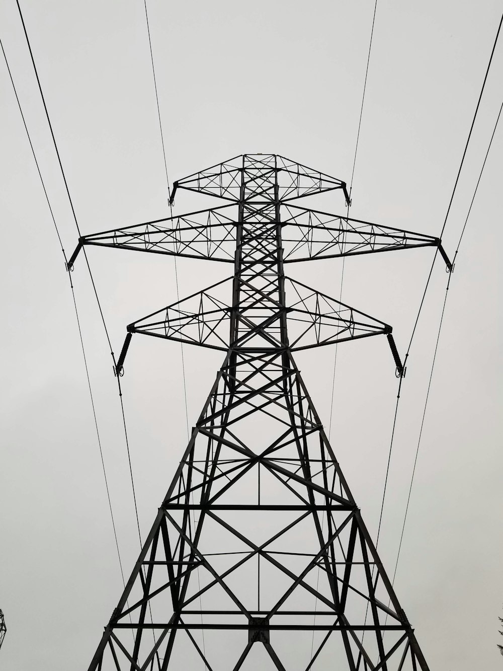 a tall tower with lots of power lines above it