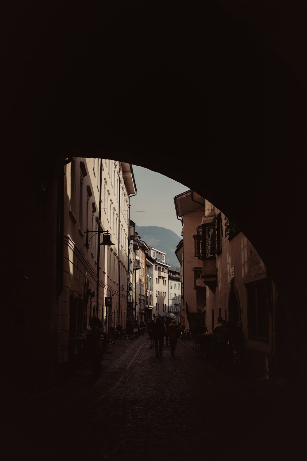 a couple of people that are walking down a street