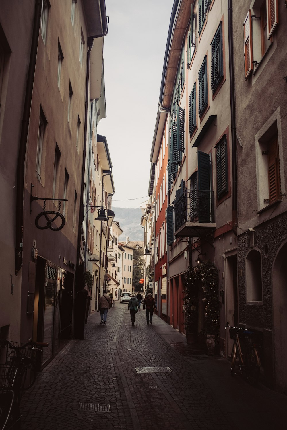 a couple of people that are walking down a street