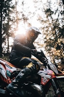 a person on a dirt bike in the woods