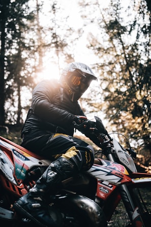 a person on a dirt bike in the woods