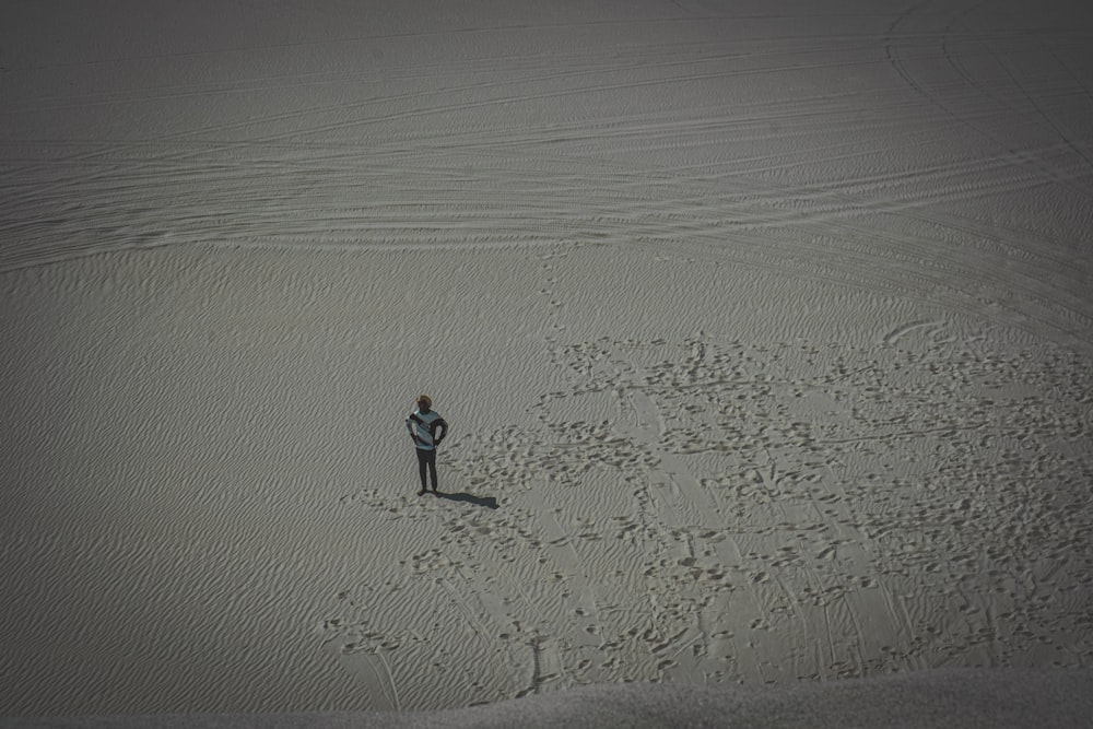 a man standing in the middle of a desert