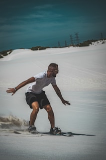 Adventure seekers sandboarding on the dunes of Timlalin.