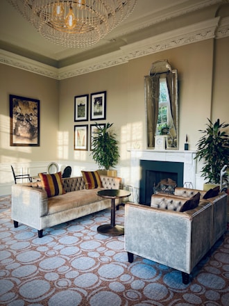A beautifully styled living room showcasing plush velvet sofas and a gleaming Italian marble dining table.