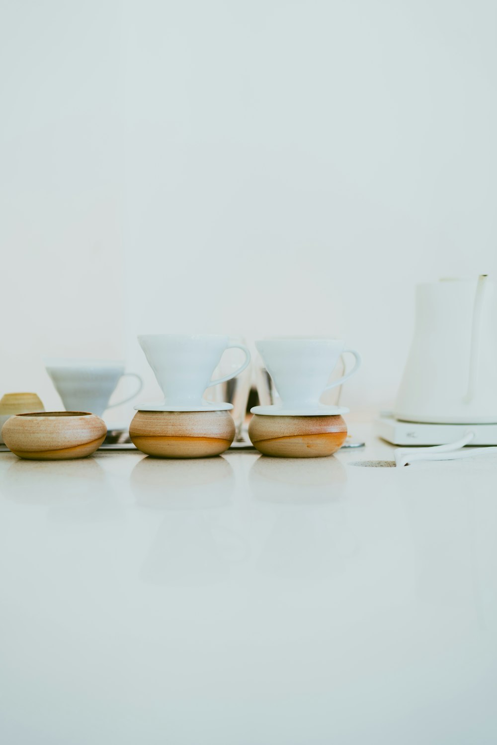 a white table topped with cups and saucers