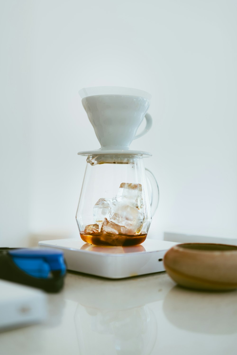 a glass pitcher filled with liquid sitting on top of a table