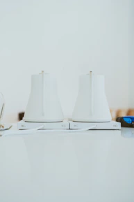 Close-up of a stylish, sleek electric kettle glowing warmly on a countertop.