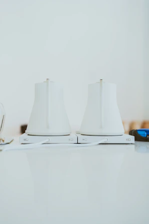 A close-up of a sleek Voltaris electric kettle glowing warmly on a kitchen counter.