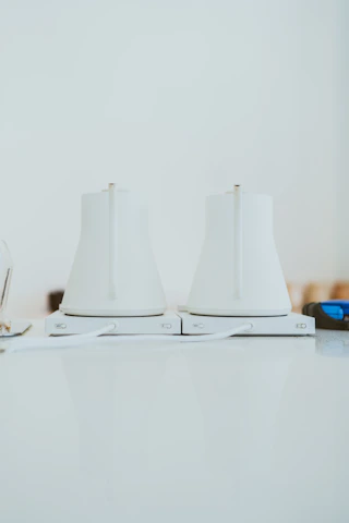 Close-up of a stylish, sleek electric kettle glowing warmly on a countertop.