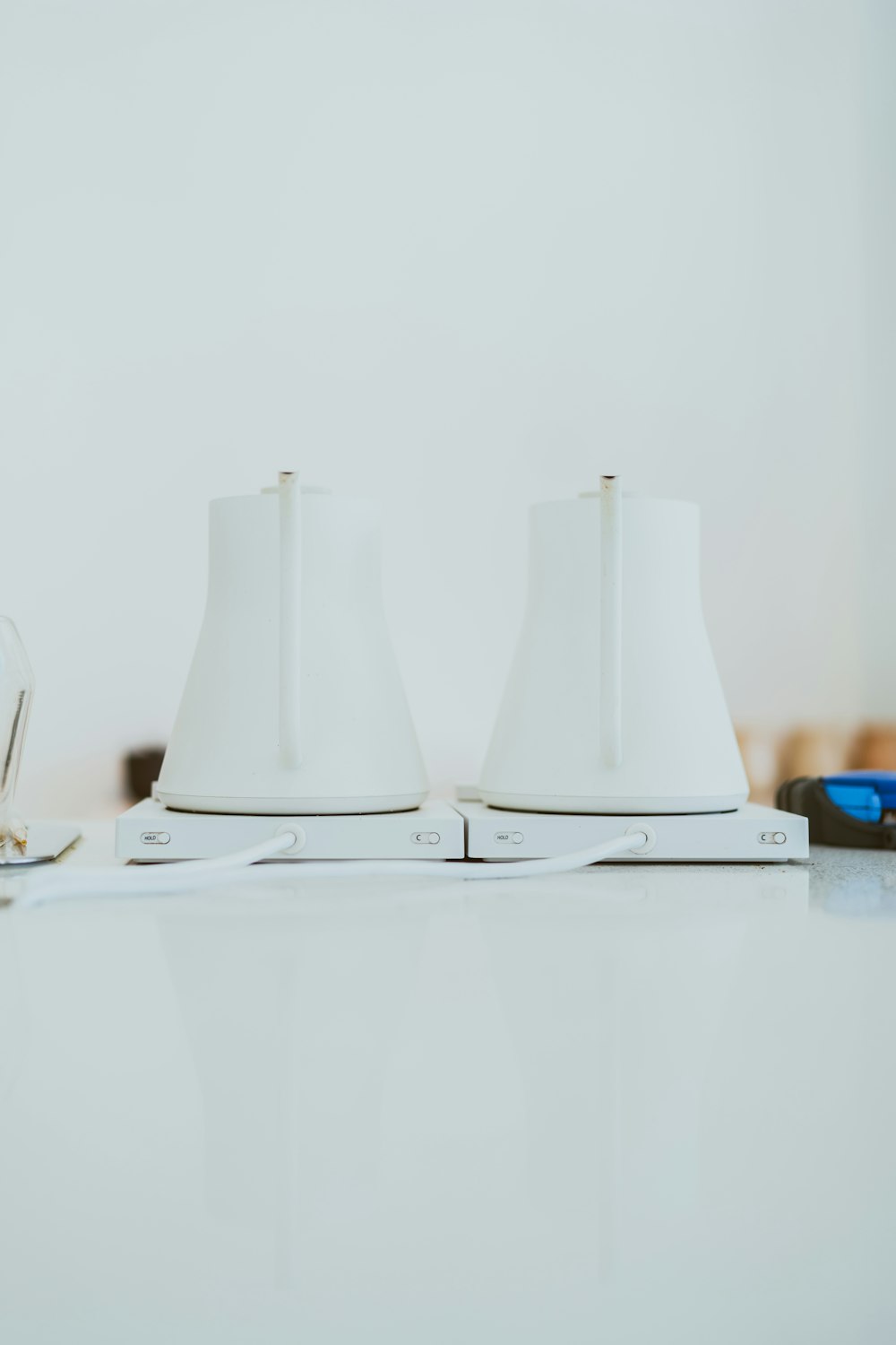 a couple of white lamps sitting on top of a table