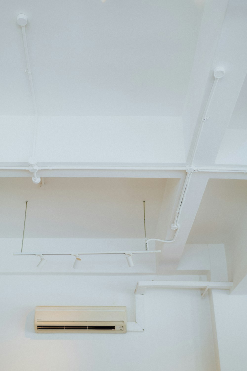 a air conditioner mounted to the ceiling of a room