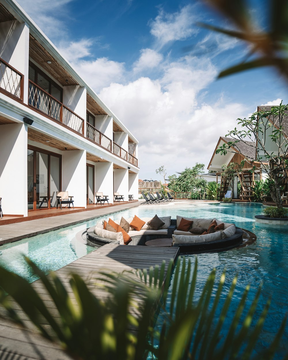 a hotel with a pool and lounge chairs