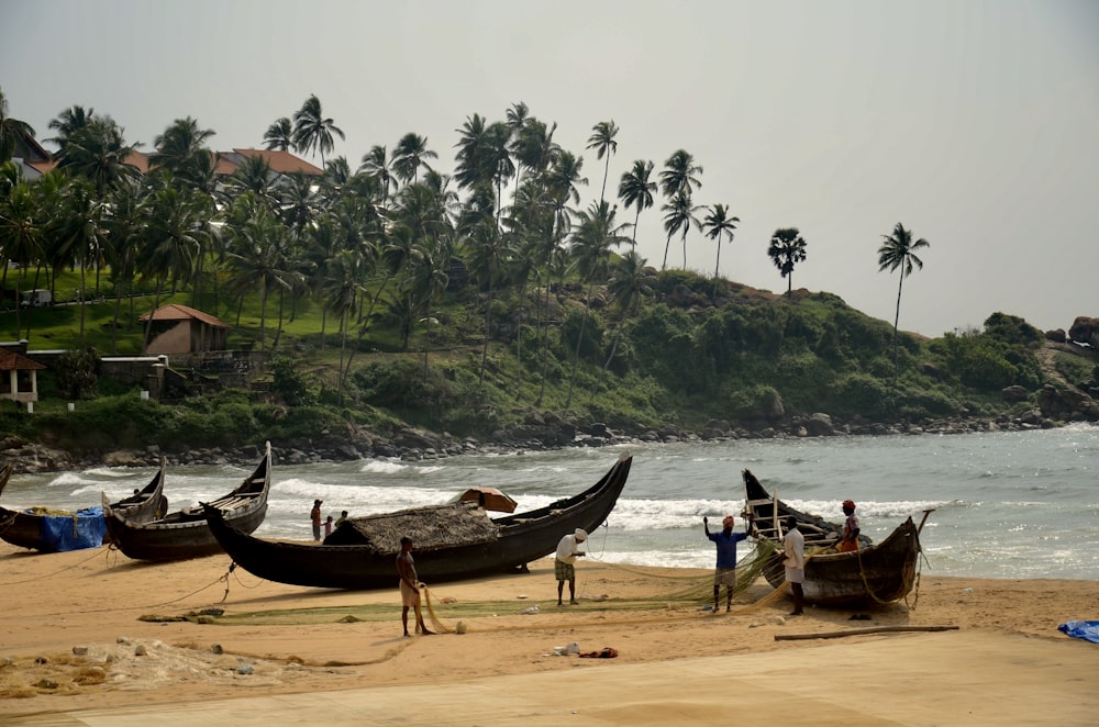 a group of boats sitting on top of a sandy beach