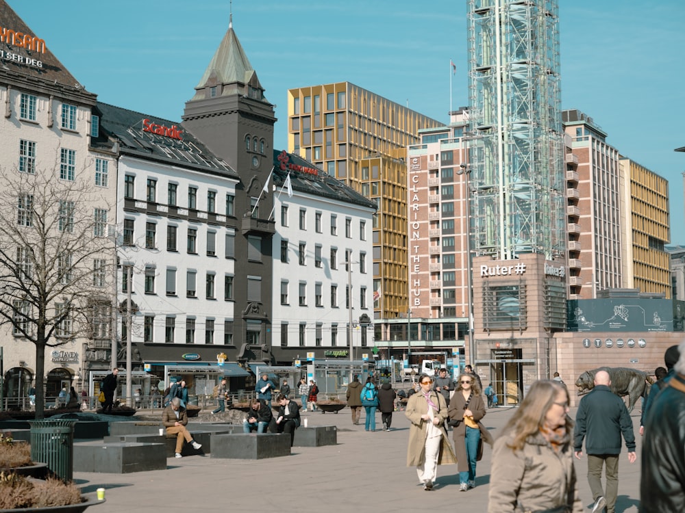 a group of people walking around a city square