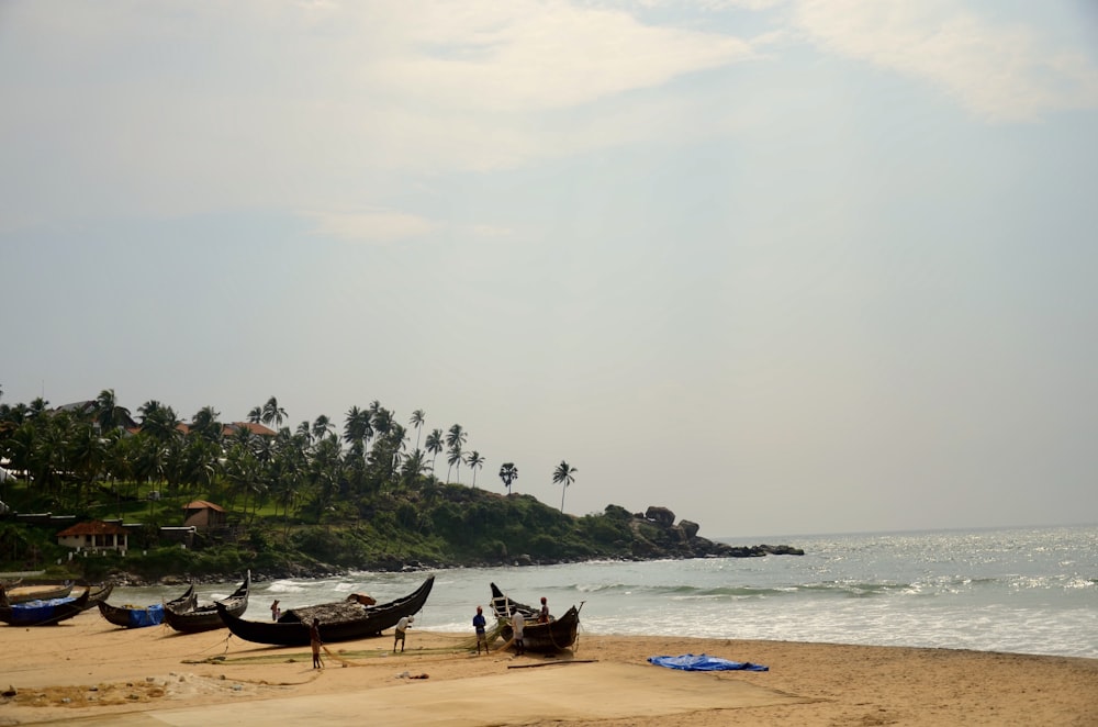 a group of boats sitting on top of a sandy beach