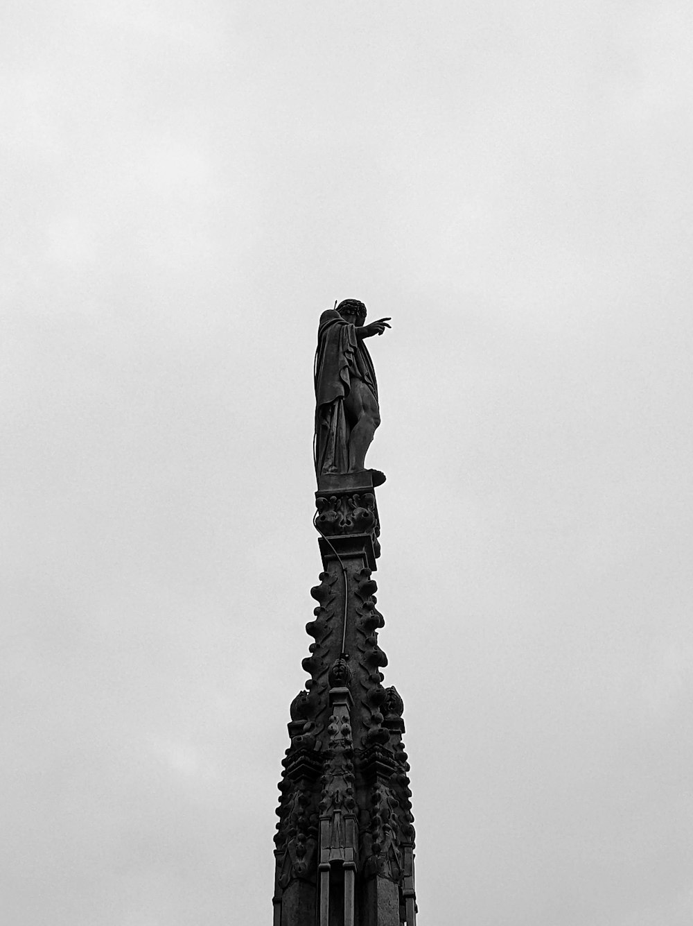 a clock tower with a statue on top of it