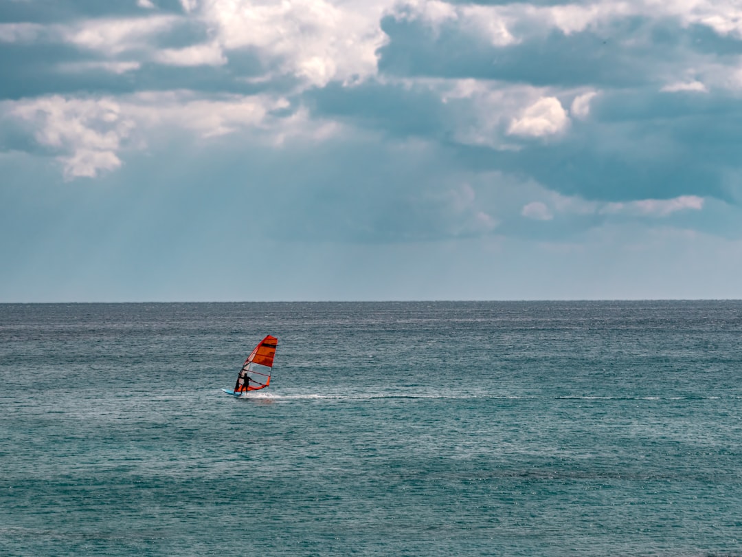 a person on a surfboard in the middle of the ocean,