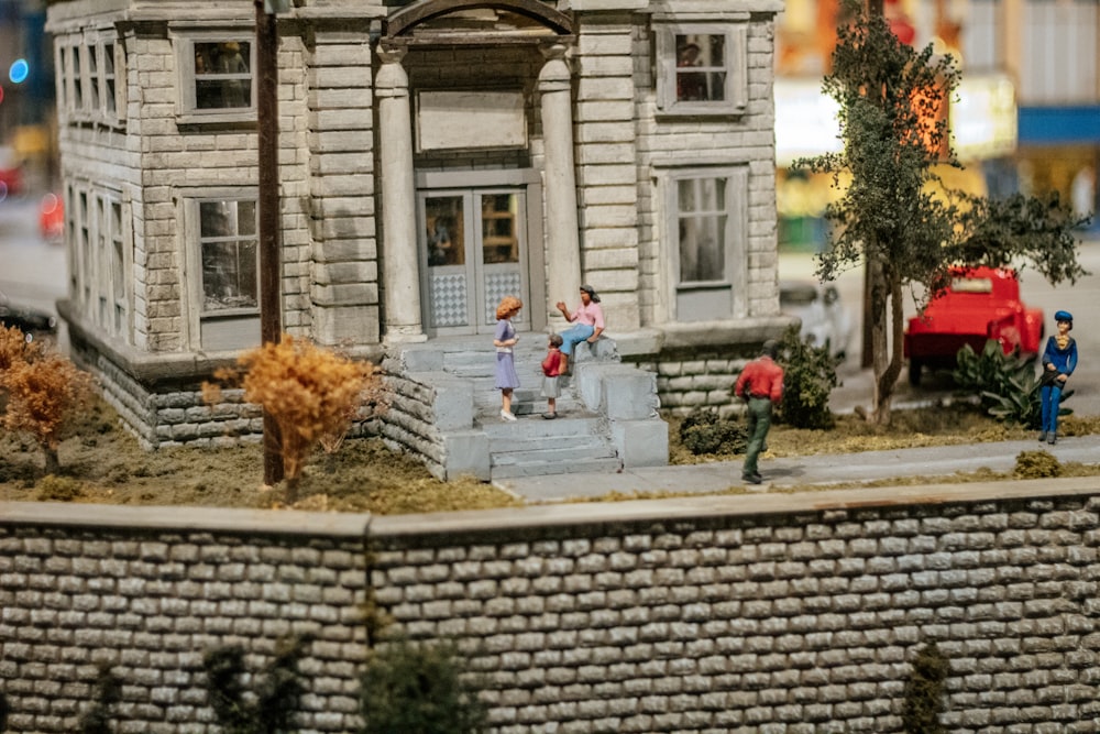 a model of a building with people walking around it