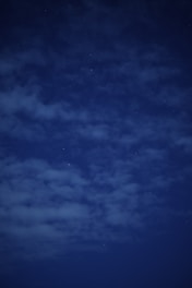 A serene night sky filled with twinkling stars over a calm landscape.