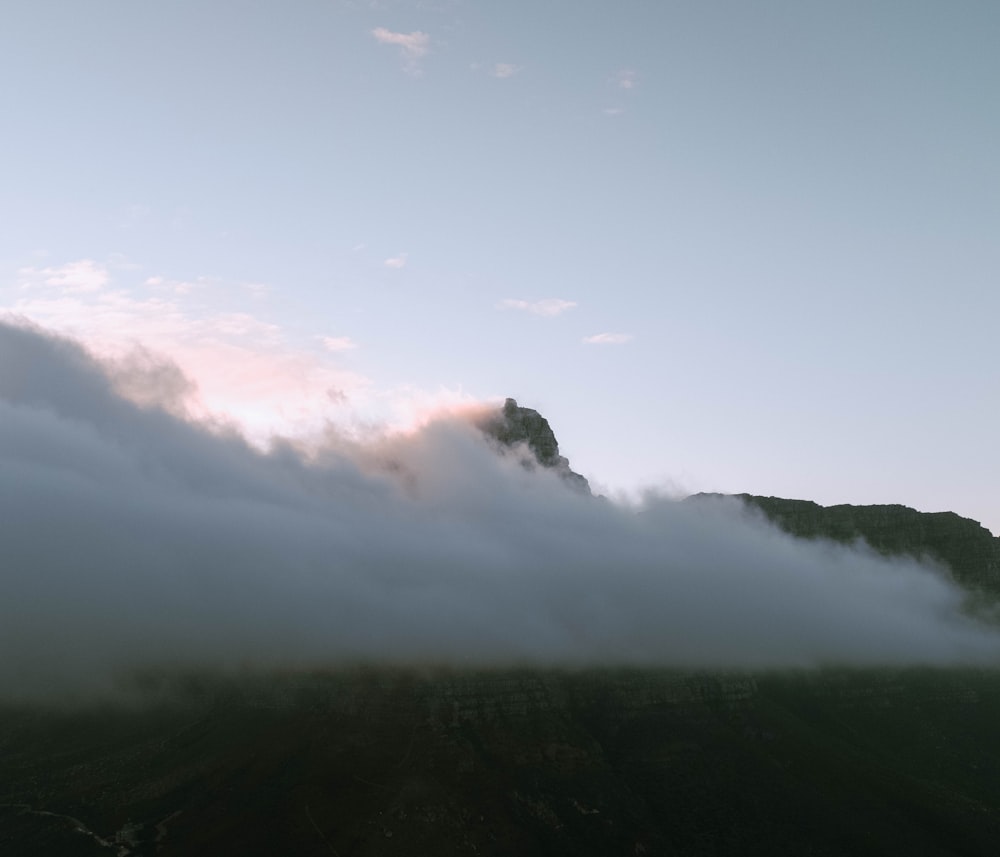 a mountain covered in a layer of fog