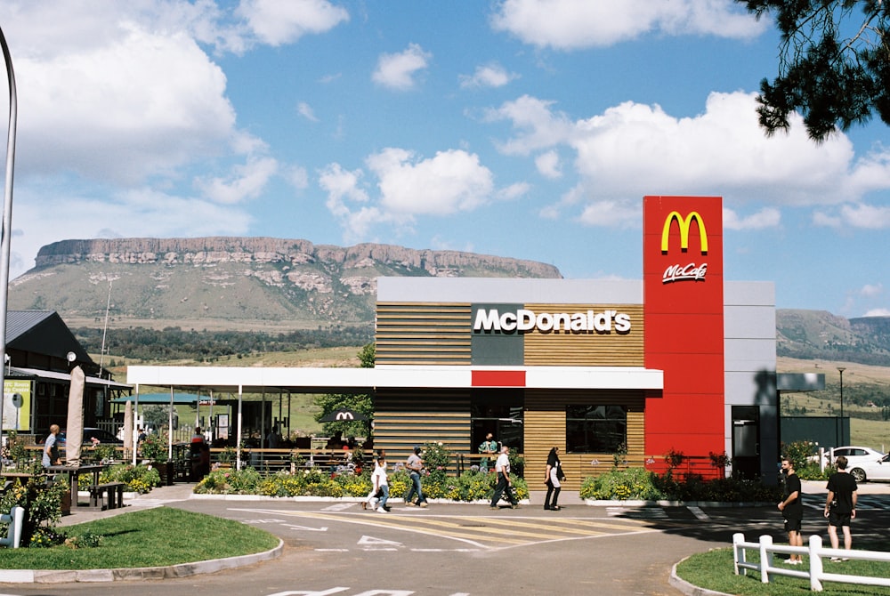 a mcdonald's restaurant with a mountain in the background