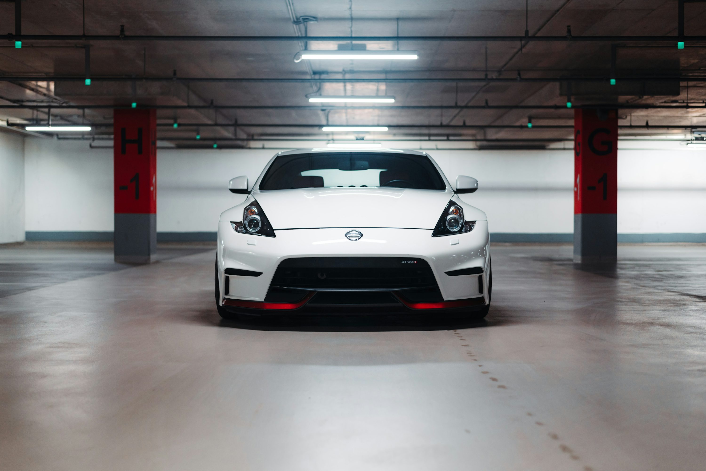 a white sports car parked in a parking garage