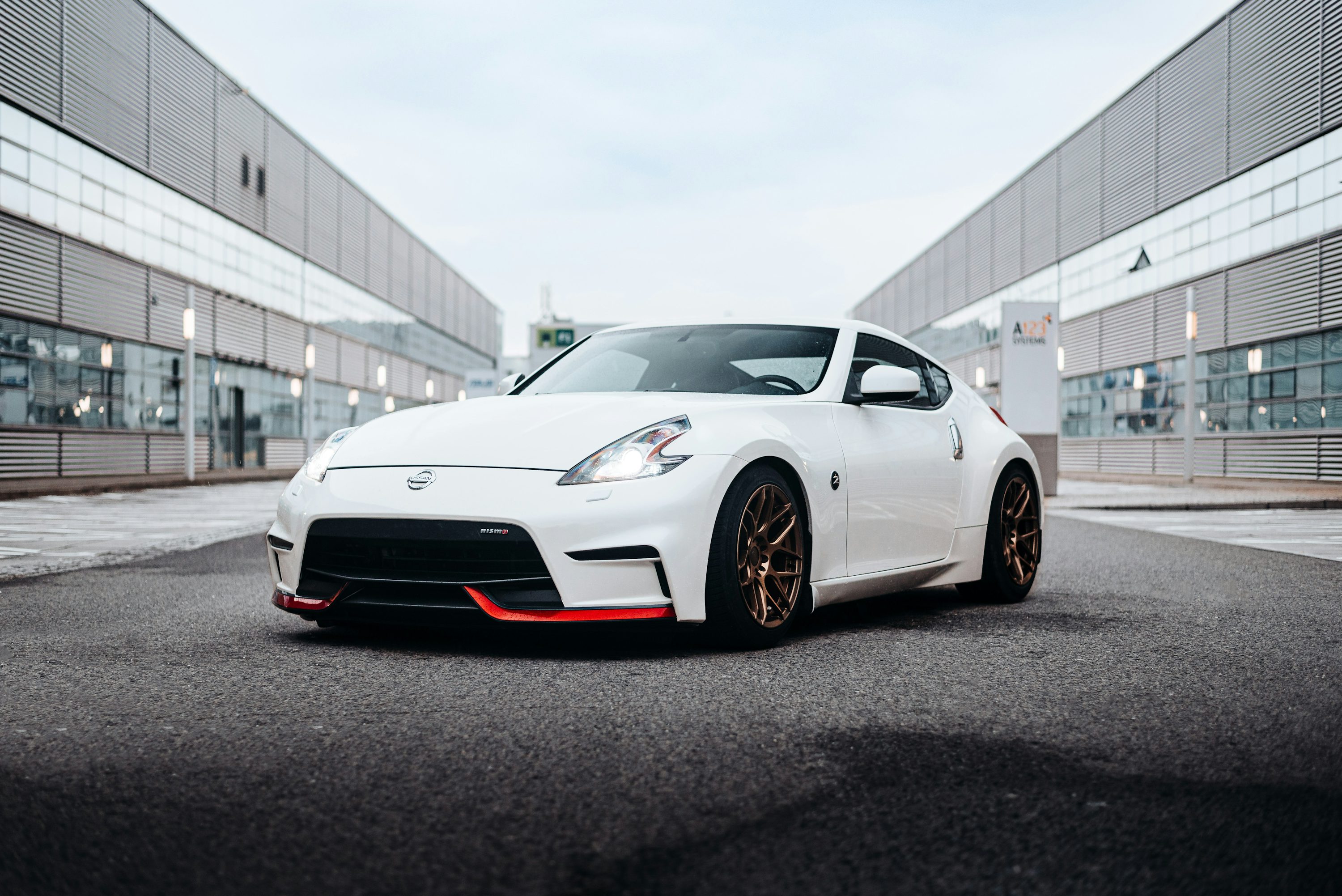 a white sports car parked in front of a building