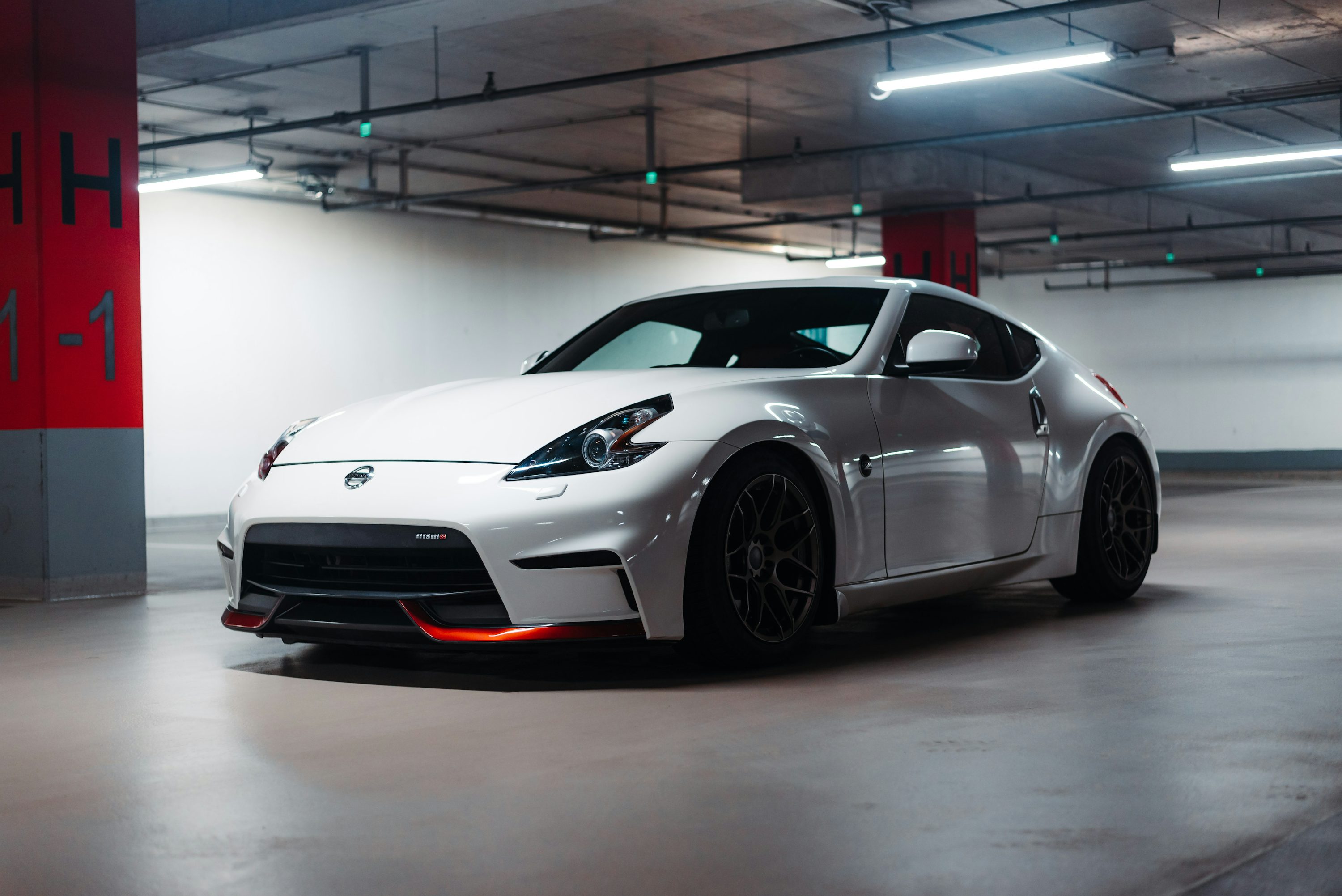 a white sports car parked in a parking garage
