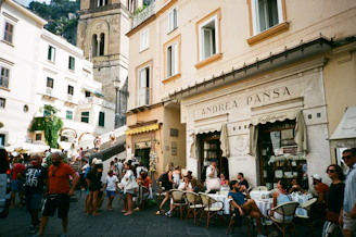 Tourists enjoying a lively street café in Torino’s historic center.