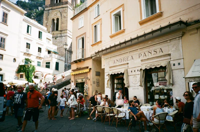 Tourists enjoying a lively street café in Torino’s historic center.