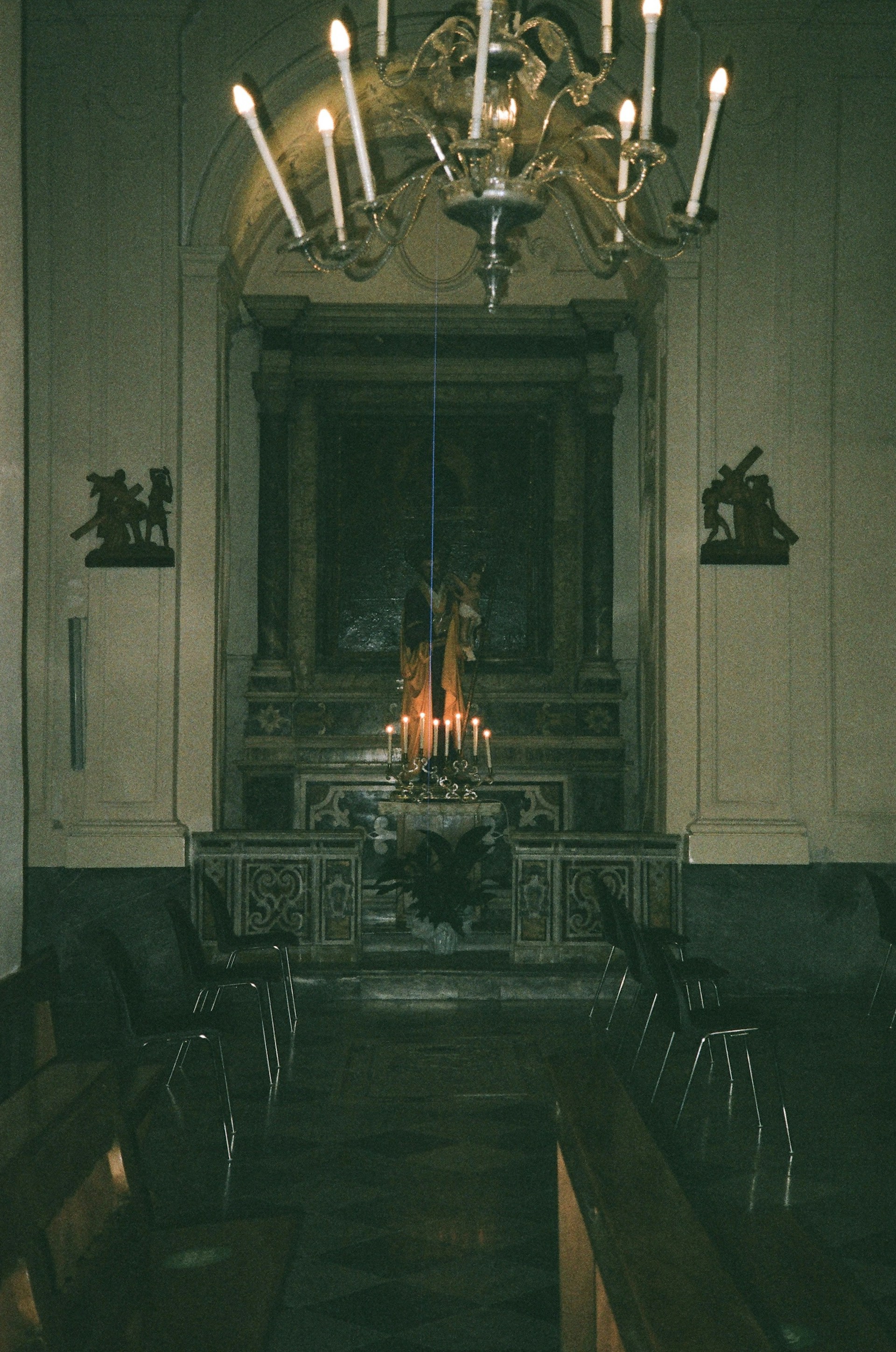 a church with a chandelier and pews