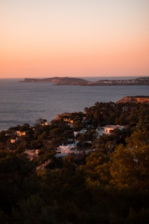 A serene view of the Naples coastline at sunset, highlighting the natural beauty of the area.
