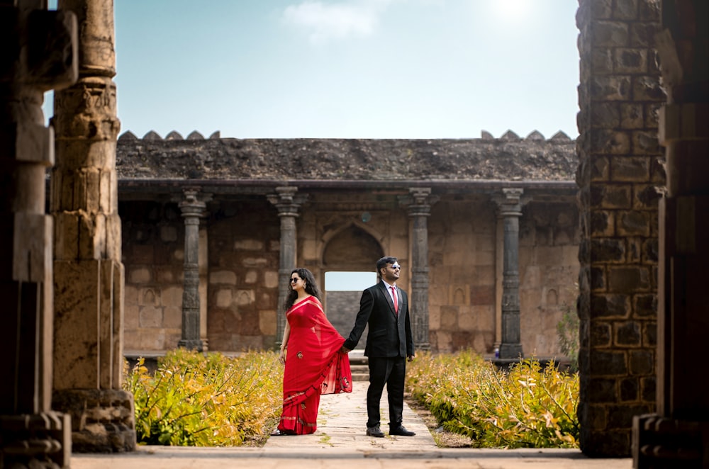 a man and a woman are standing in a courtyard