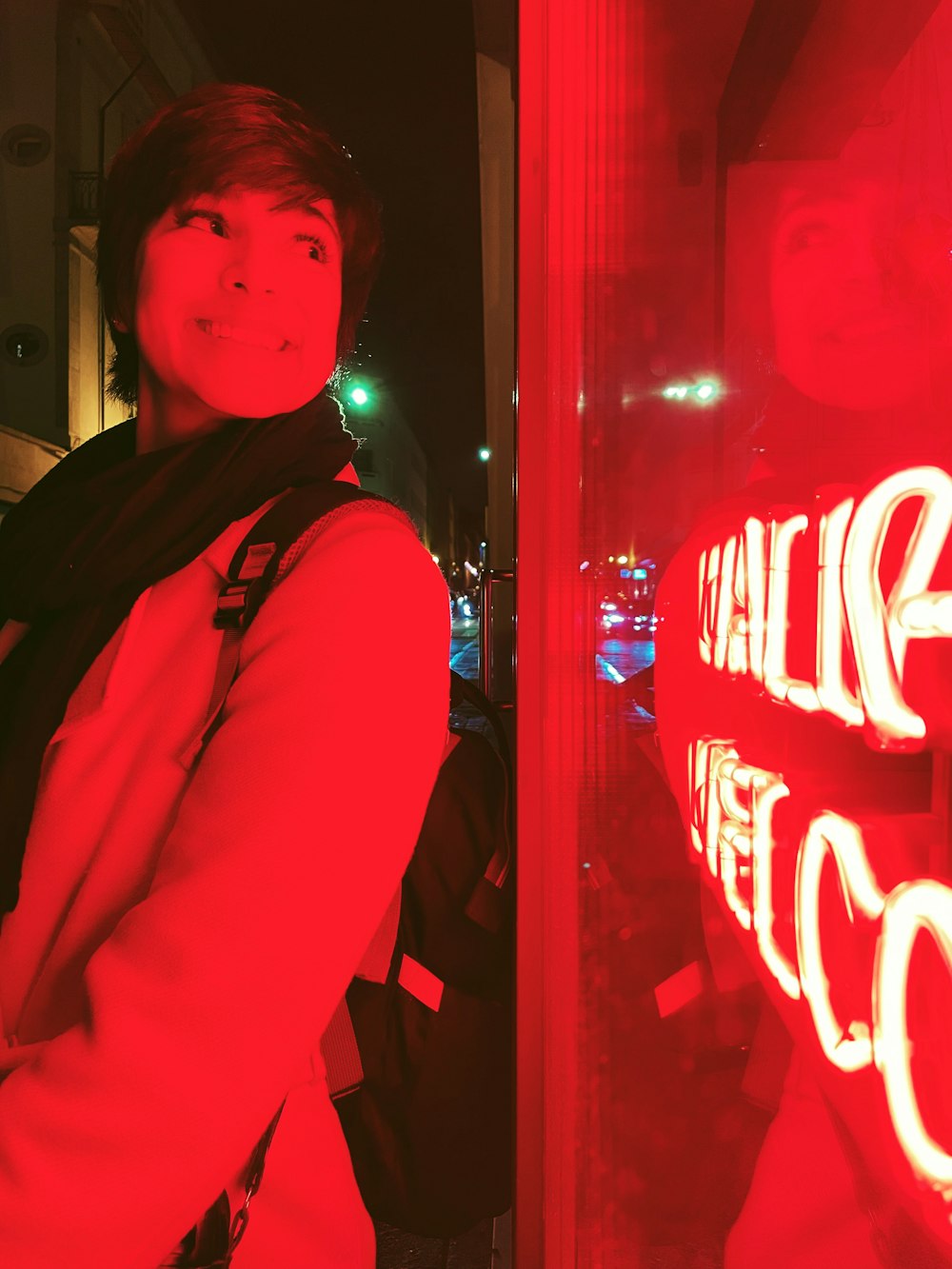 a woman standing in front of a red light