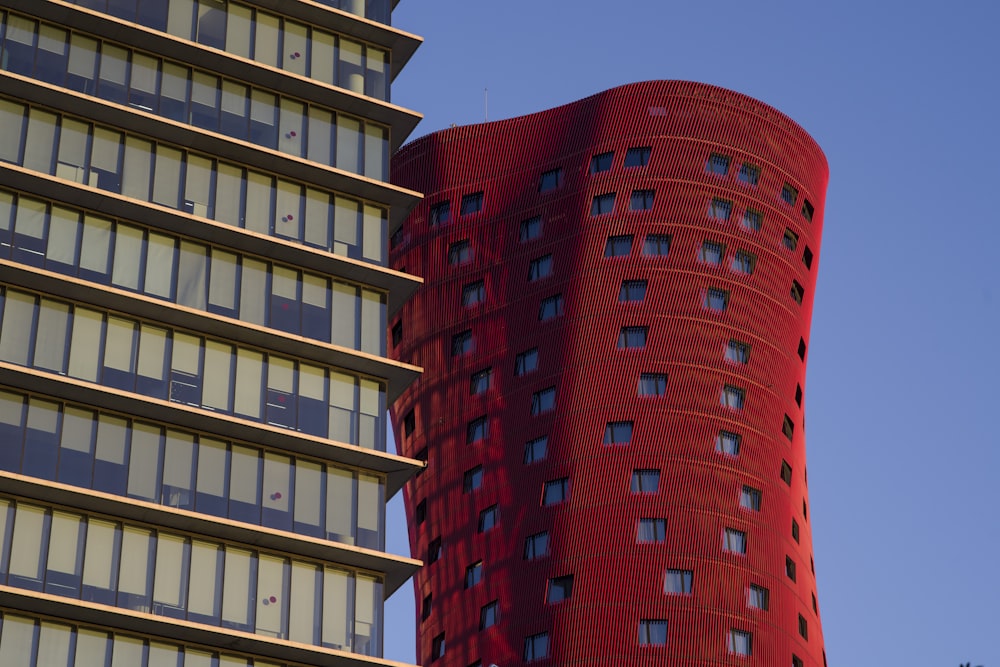 a tall red building next to a tall building