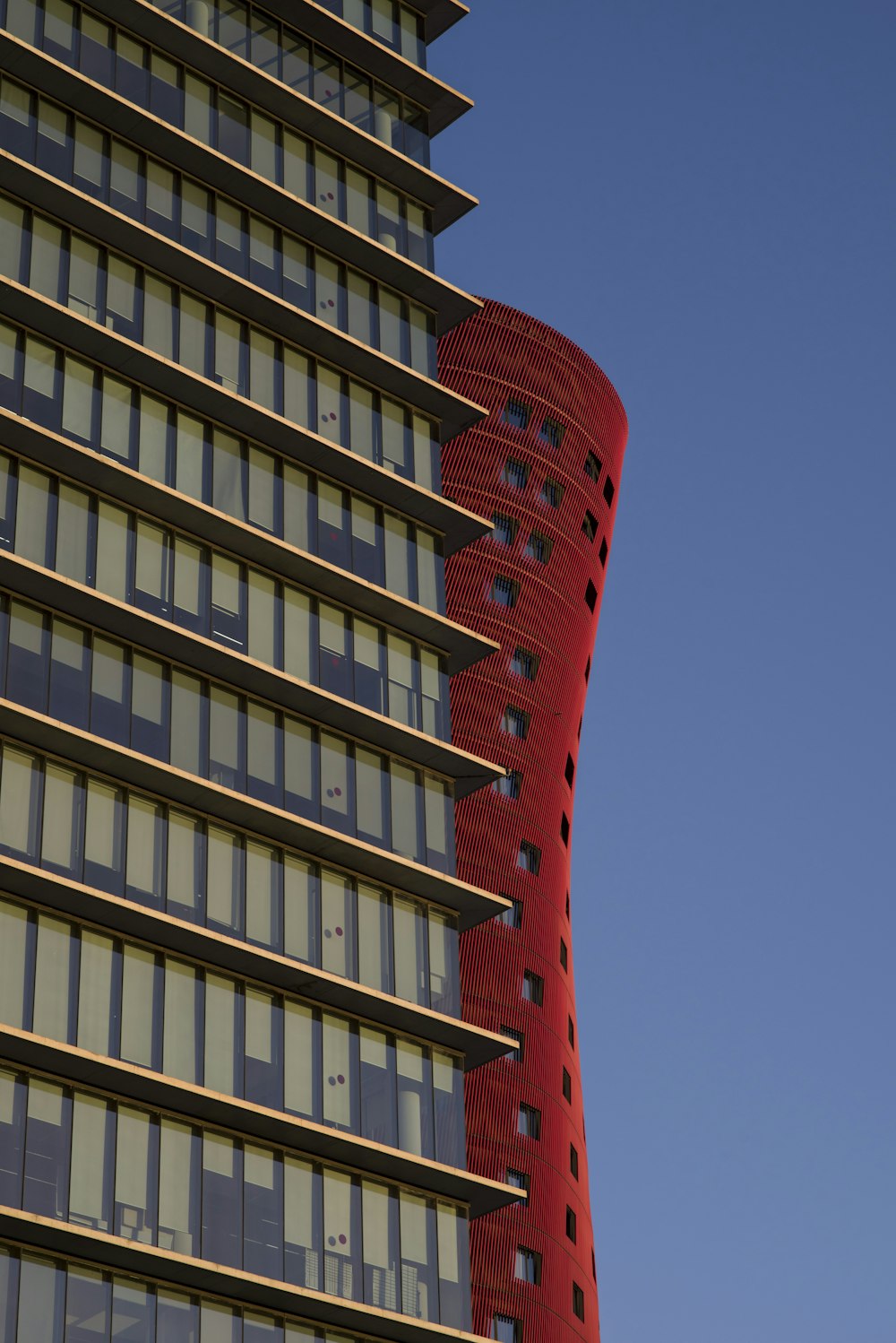 a tall building with a red tower on top of it