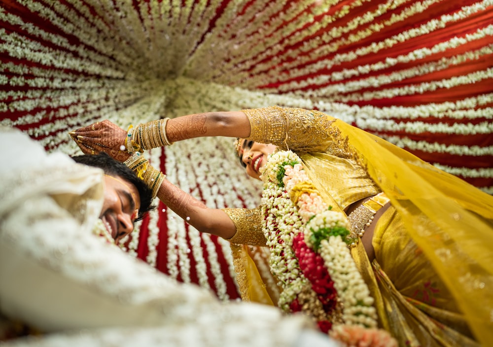 a woman in a yellow dress and a man in a white suit