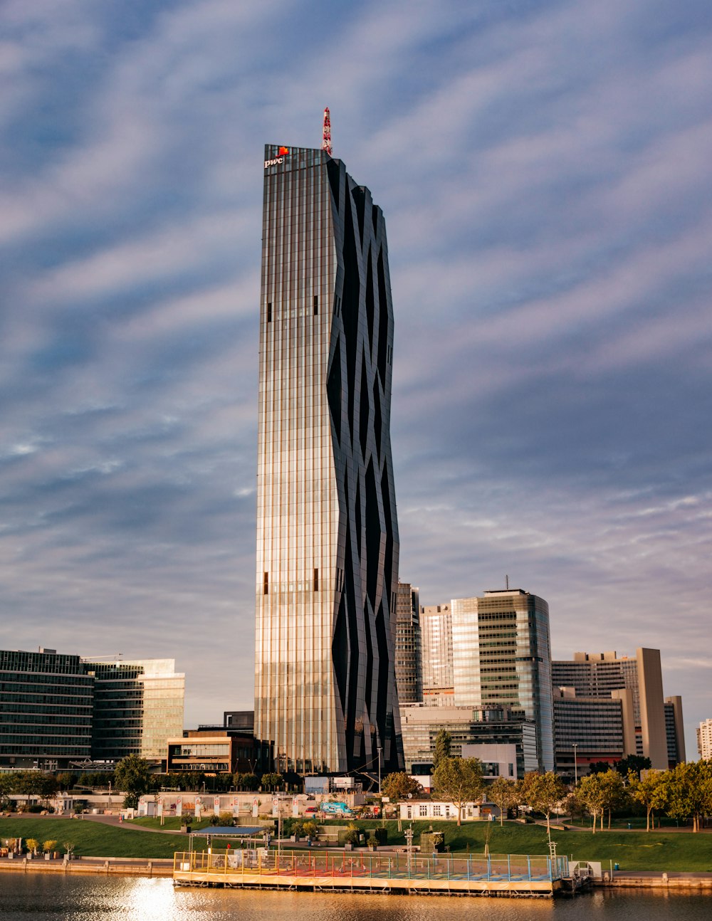 a very tall building sitting next to a body of water