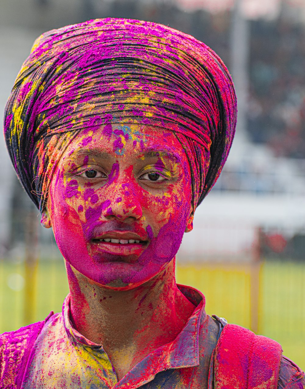 a man with a turban on his head covered in colored paint