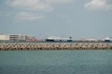 a large cargo ship in the water next to a dock