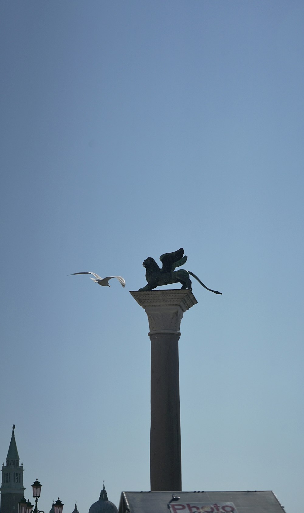 a statue of a lion on top of a pillar