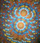 An action card showcasing a dynamic, pulsating mandala design in warm colors.