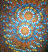 A vibrant mandala pattern being designed on a web app interface.