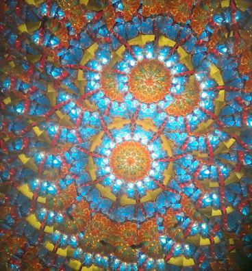 An action card showcasing a dynamic, pulsating mandala design in warm colors.