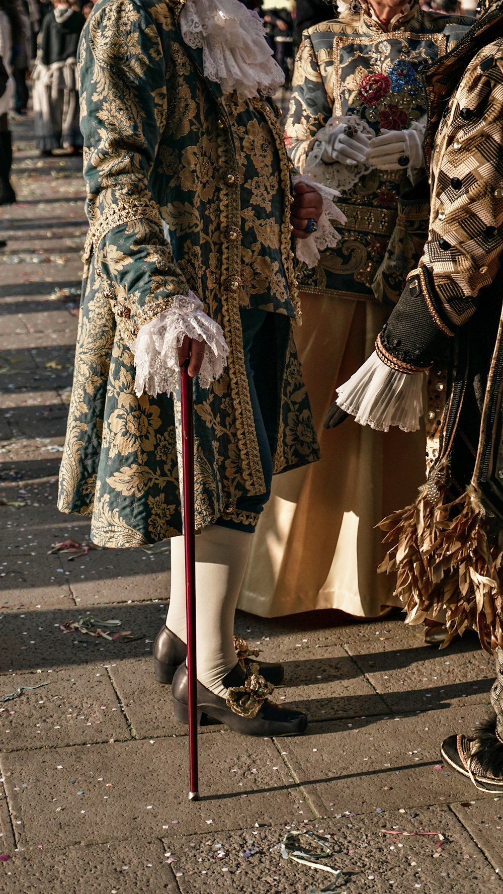 a group of people standing next to each other on a sidewalk