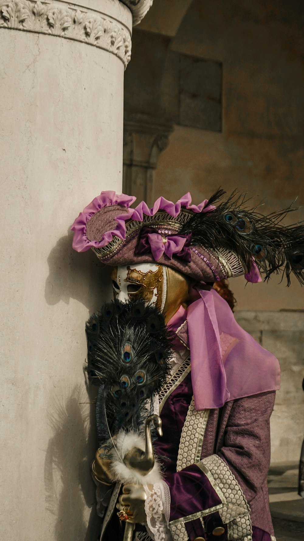a masked man wearing a purple and black costume